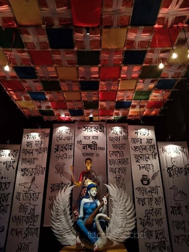 a statue in the middle of a room with many signs on the walls and ceiling