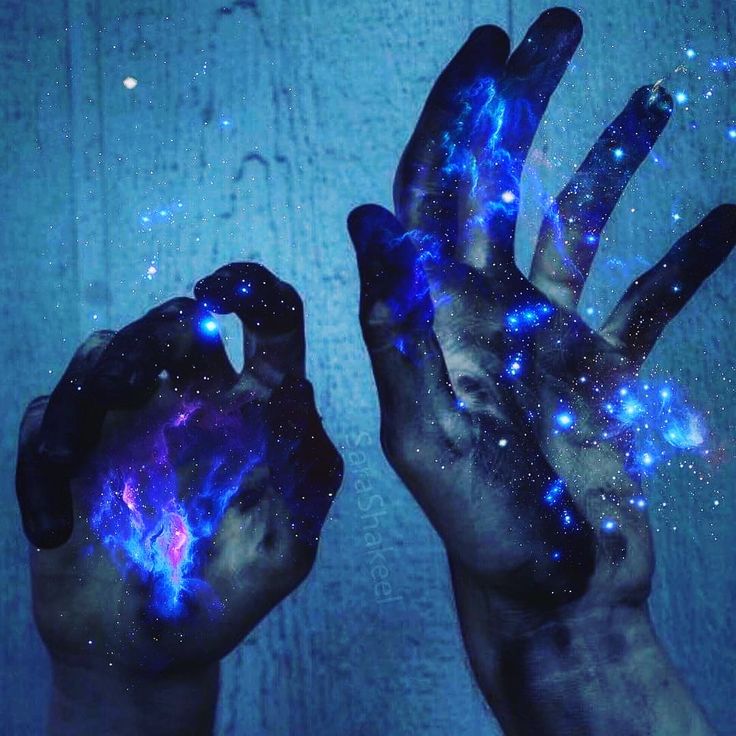 two hands are shown with blue and purple lights in the middle of their palms