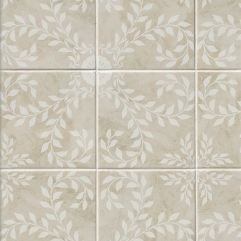 a tile wall with white leaves on the top and bottom tiles in different sizes, shapes and colors