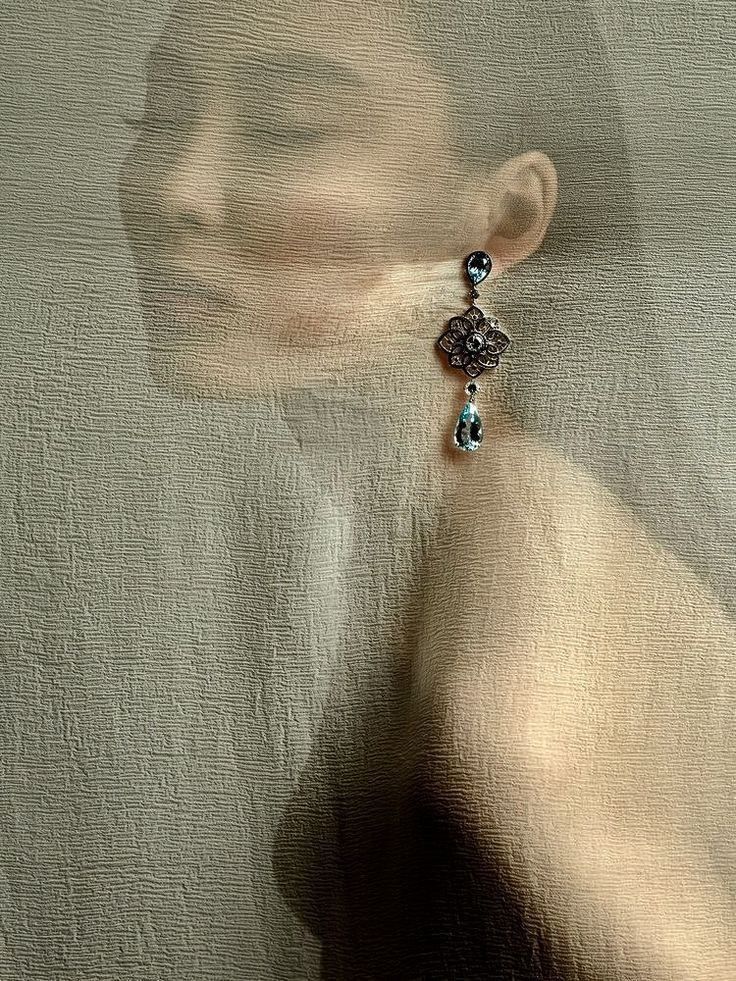 a close up of a person's face with a necklace hanging from the neck