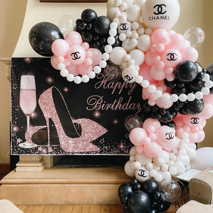 a birthday party with balloons and chanel shoes on the front, black and white