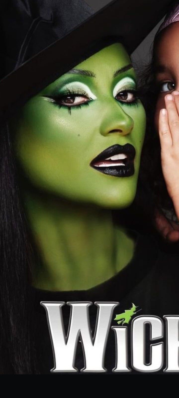 a woman with green makeup and witch make - up on her face is covering her eyes