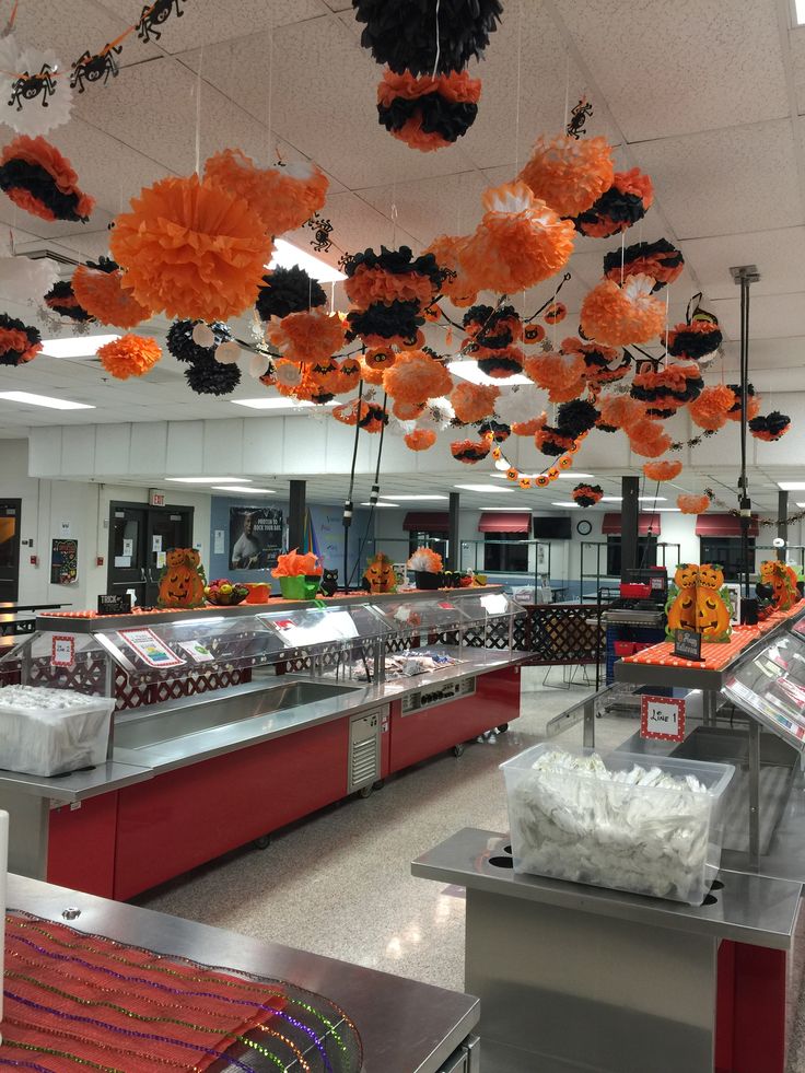 the food court is decorated with orange and black pom poms