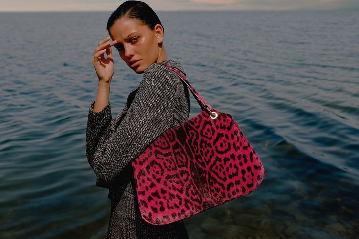 Flawlessly balancing vintage design and modern utility, perfectly organized with its different compartments. Its refined and functional style easily transitions from life in the city to last.
 
Printed leopard calf hair in fuchsia color

 
Two handles and detachable shoulder strap

 
One central zip compartment and one open compartment on the side.

 
Metal clip fastening

 Gold-toned hardware Made in Spain H28cm x W39cm x D14cm Leopard Print Handbags, Modern Utility, Life In The City, Leopard Print Bag, Perfectly Organized, Leopard Bag, Handbag For Women, Fuchsia Color, Calf Hair