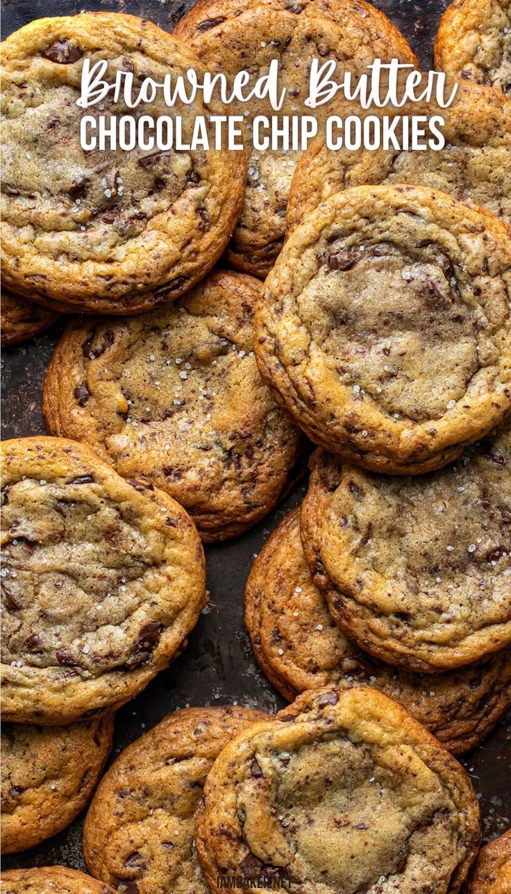 many browned butter chocolate chip cookies are on a dark surface together. Brown Butter Chocolate Chip Cookies No Chill, Gooey Brown Butter Chocolate Chip Cookies, Butter Chip Cookies, Whole Foods Brown Butter Chocolate Chip Cookies, Brown Butter Chocolate Chip Cookies Ambitious Kitchen, Salted Butter Chocolate Chip Cookies, Whole Foods Brown Butter Cookies, Ripple Chocolate Chip Cookies, Sweet Martha's Chocolate Chip Cookies