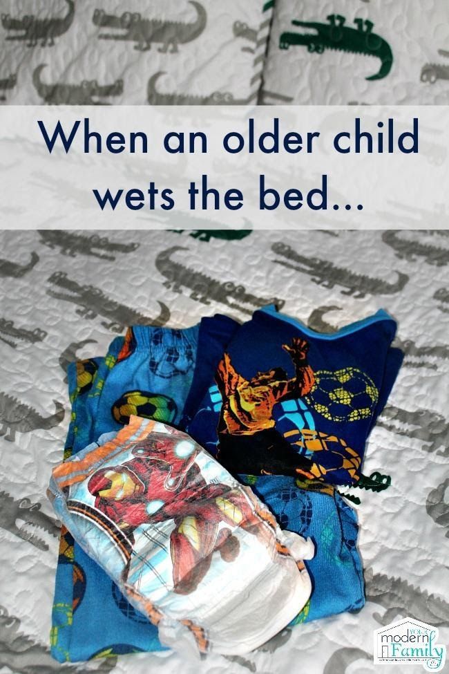 an image of a bed with clothes on it and the words when an older child wets the bed