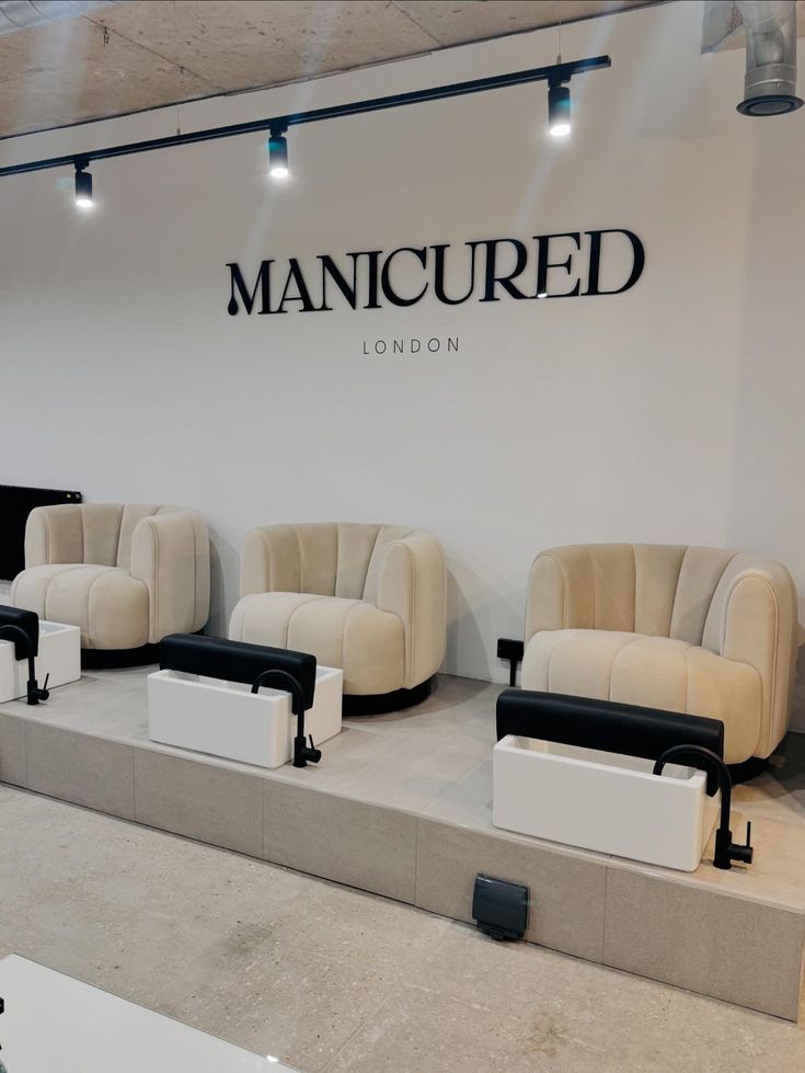 several couches and chairs in front of a manicured sign on the wall