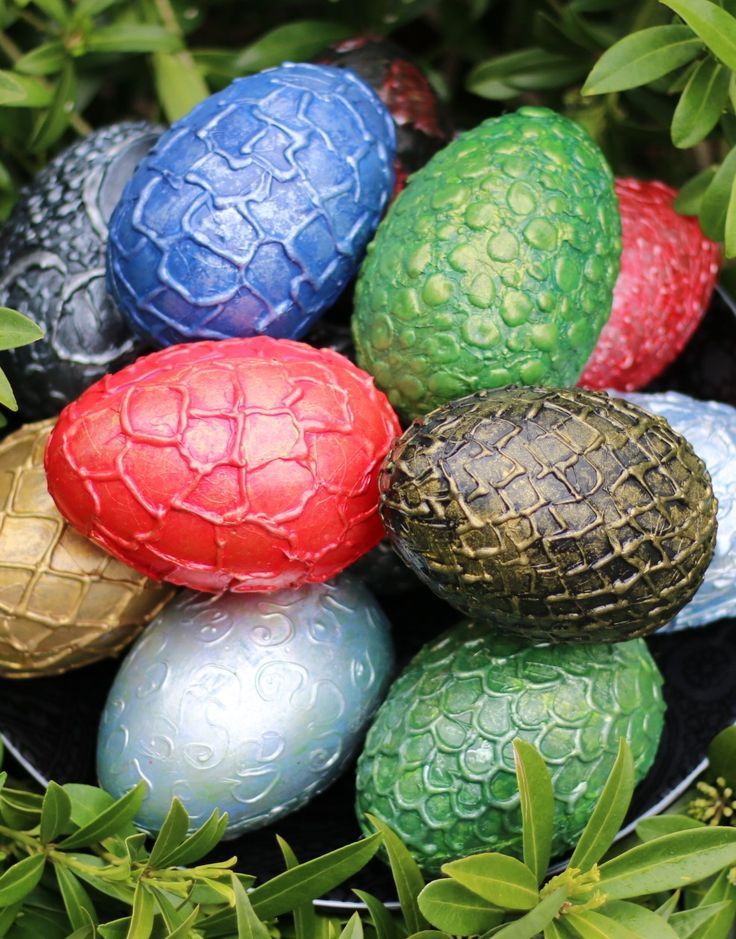 some colorful eggs are sitting in the grass