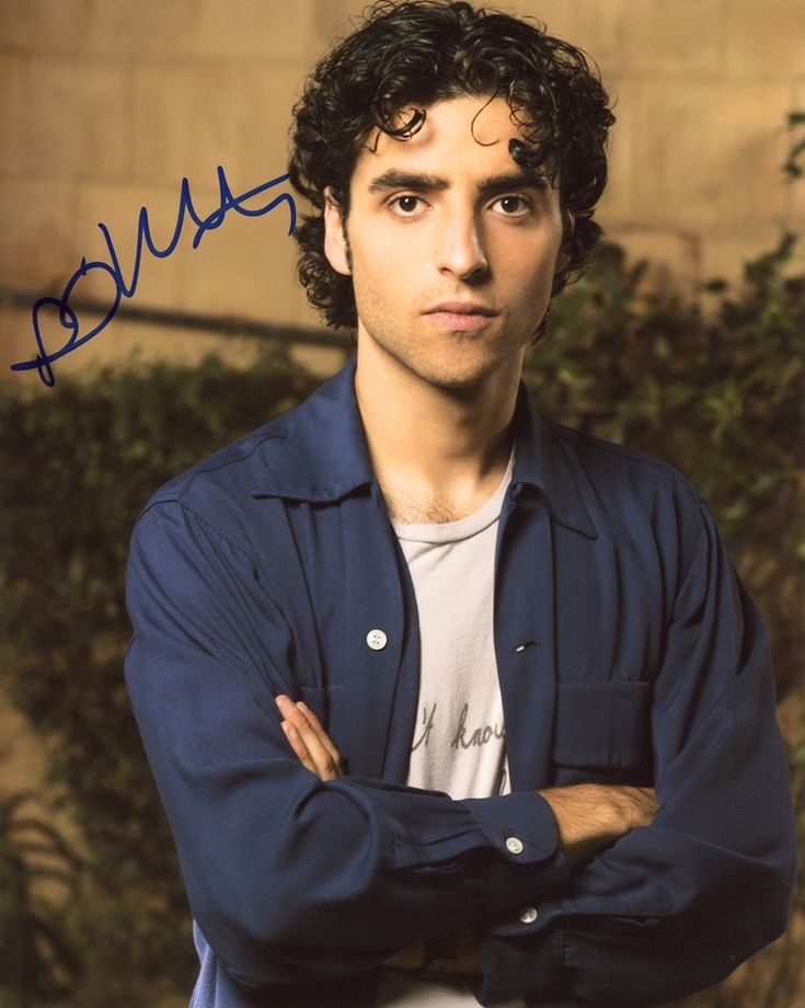 a man with his arms crossed posing for a photo