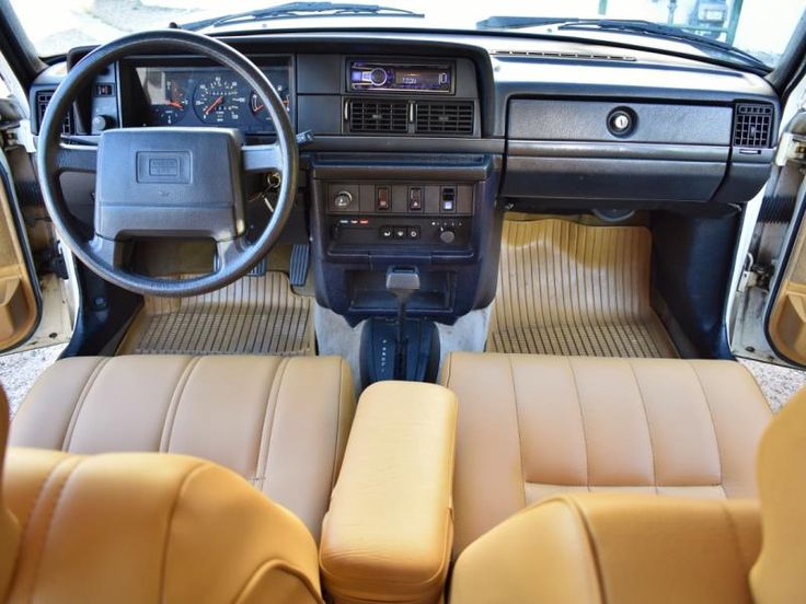 the interior of a car with tan leather seats