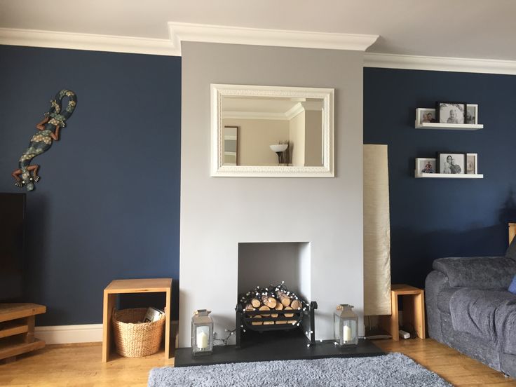 a living room with blue walls and furniture