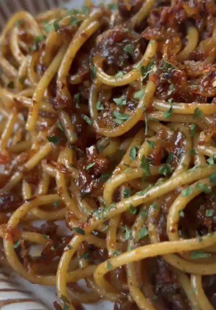 pasta with meat and parmesan cheese on a plate