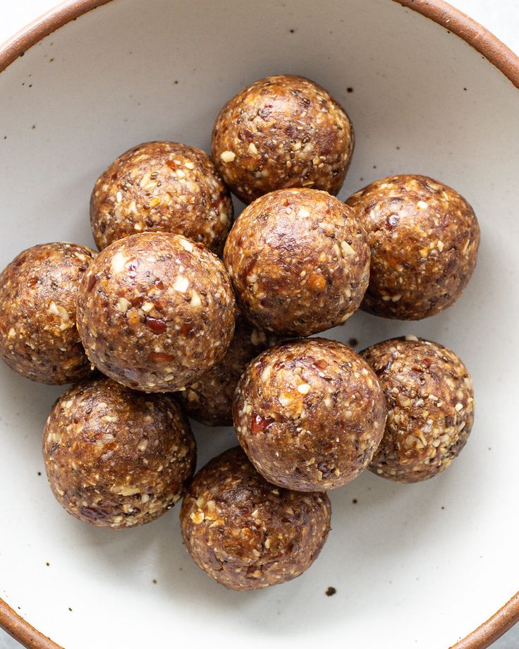 a white bowl filled with chocolate energy balls