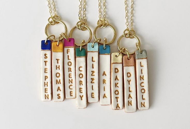 four necklaces with different words on them