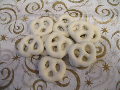 eight white plastic buttons sitting on top of a fabric covered tablecloth with gold stars and swirls