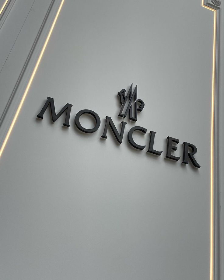 the sign for moncler is illuminated in black