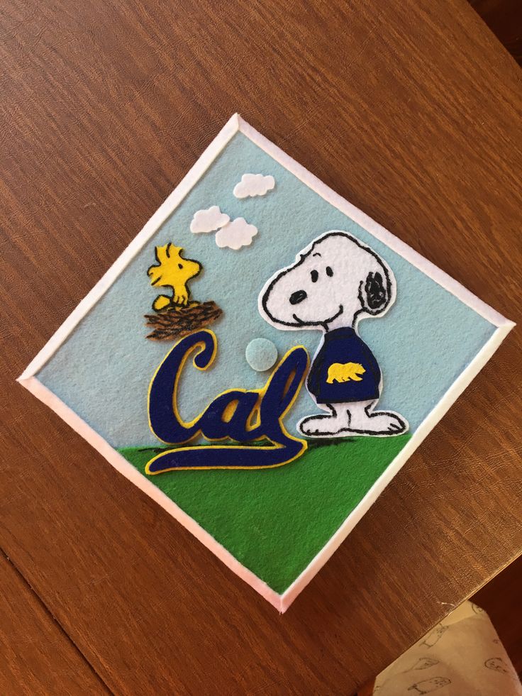 a close up of a card on a table with a snoopy bear and bird