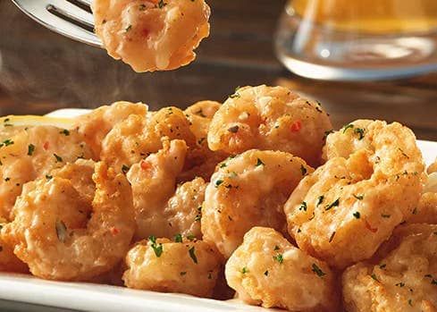 a white plate topped with tater tots next to a fork