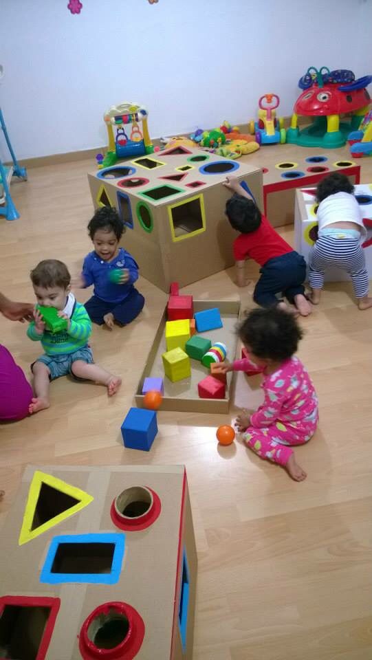 children playing with toys on the floor in a playroom