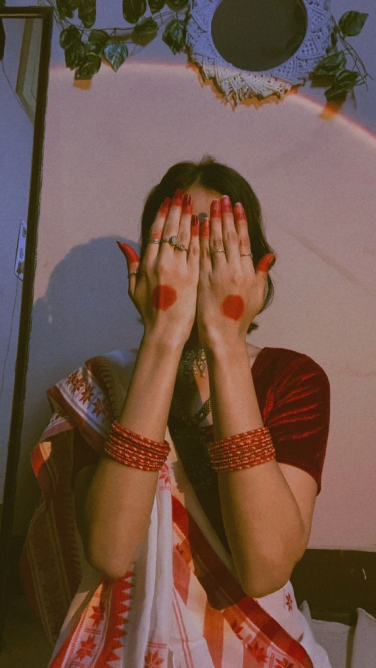 a woman covering her eyes with both hands