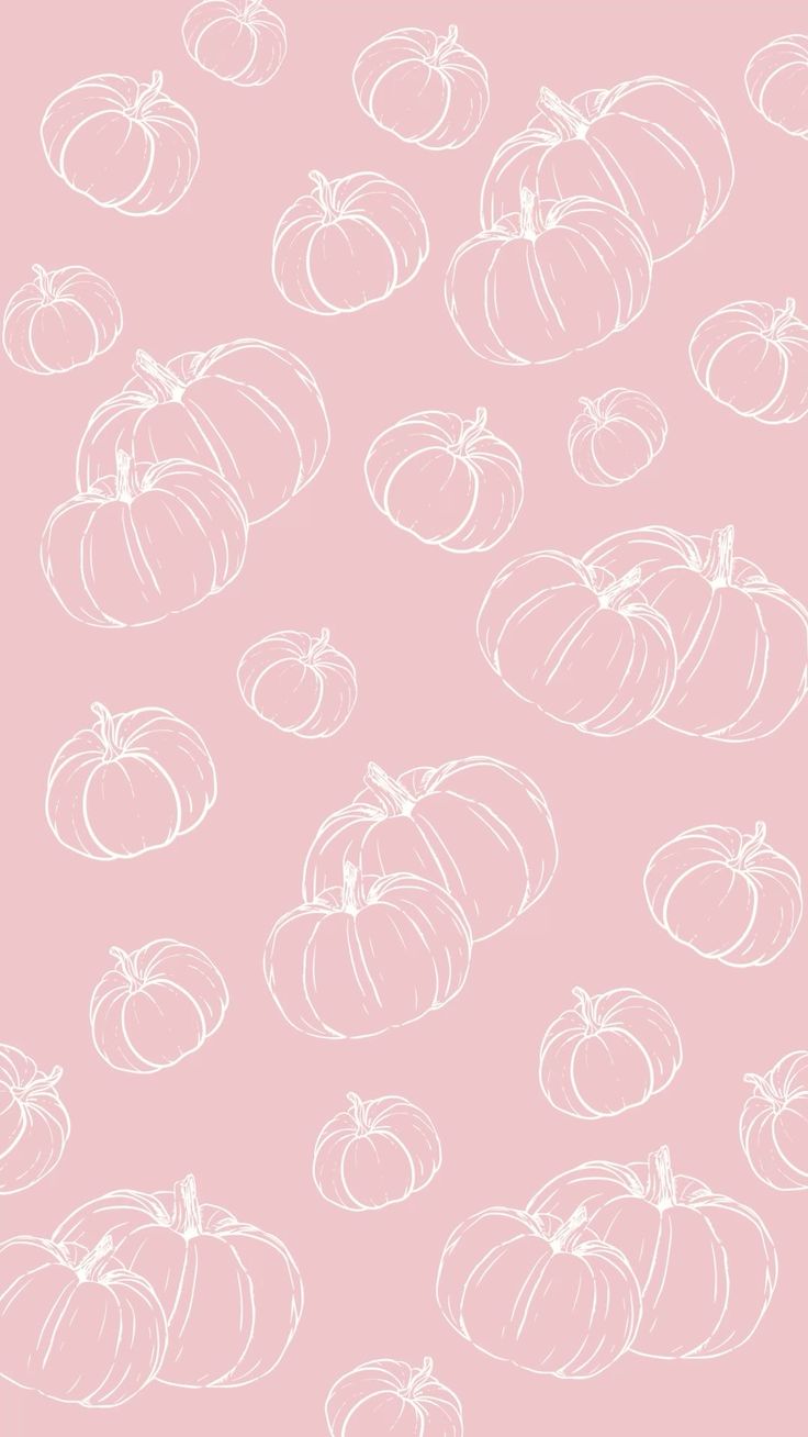 a pink background with white pumpkins on it