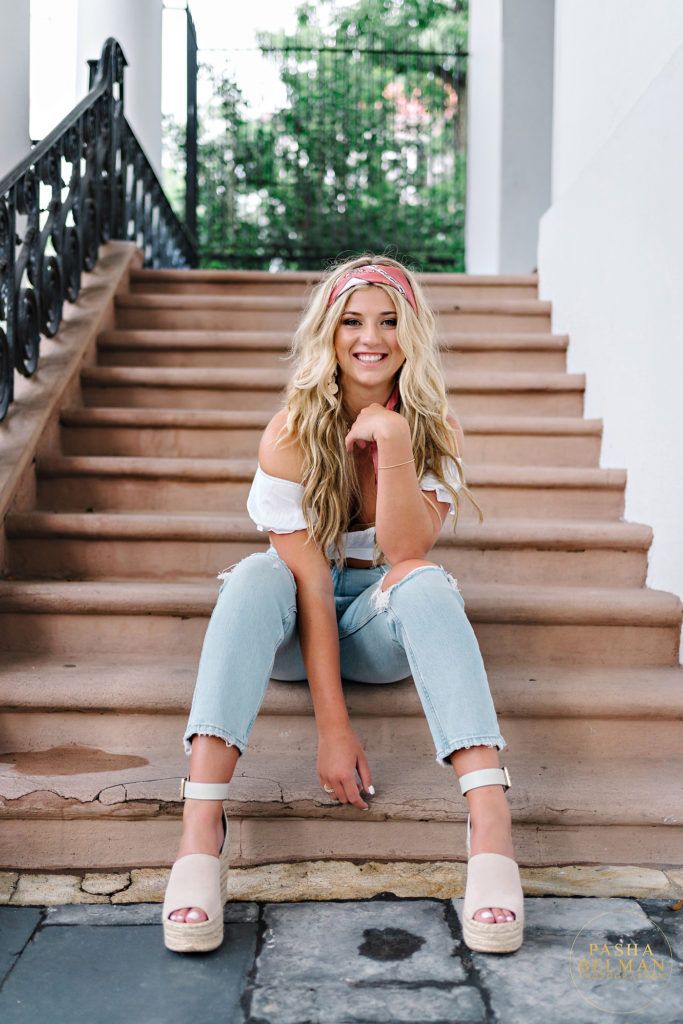 a beautiful blonde woman sitting on the steps