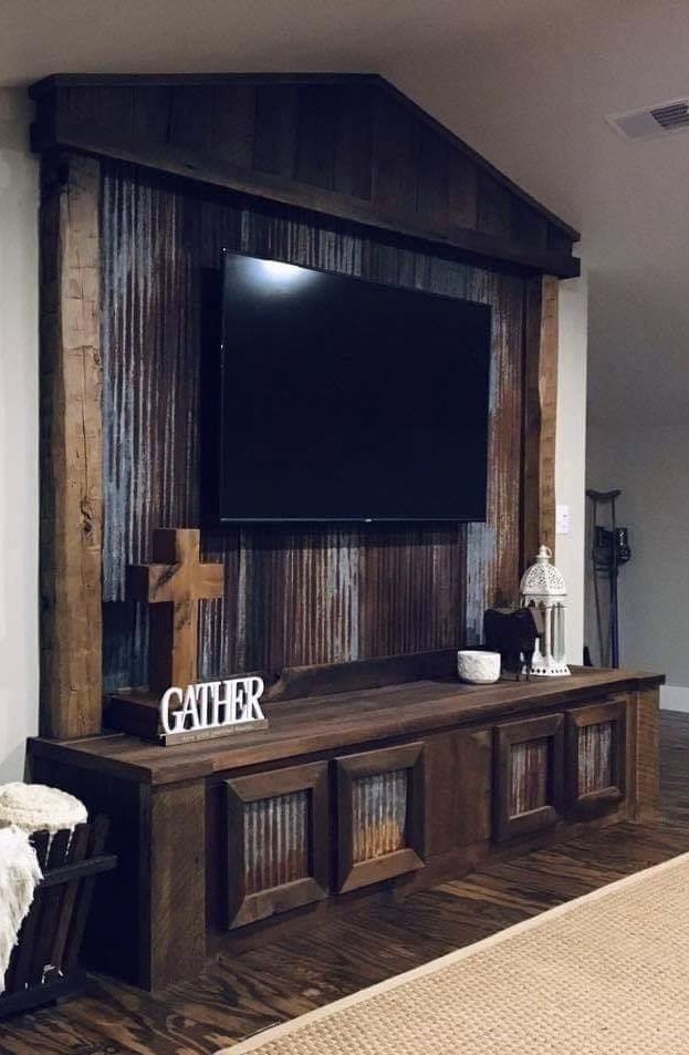 a living room with a large tv mounted to the wall