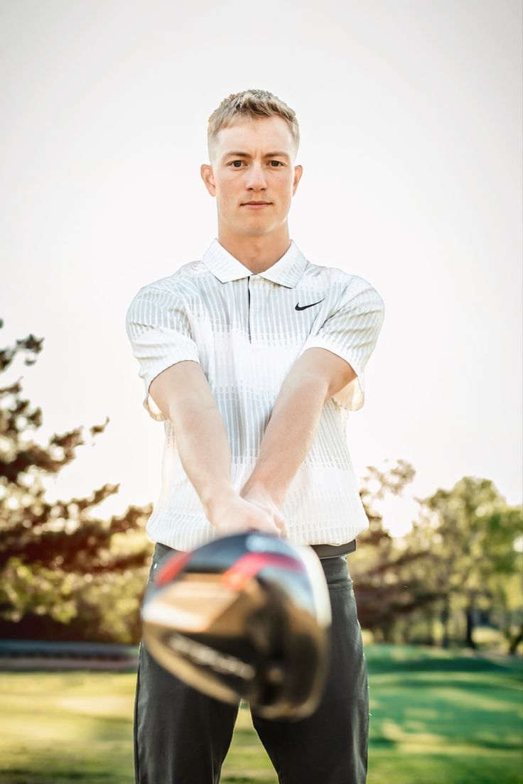 a man holding a baseball bat in his right hand