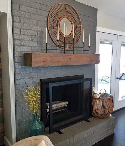 a living room with a fire place and a mirror on the wall above it's mantle