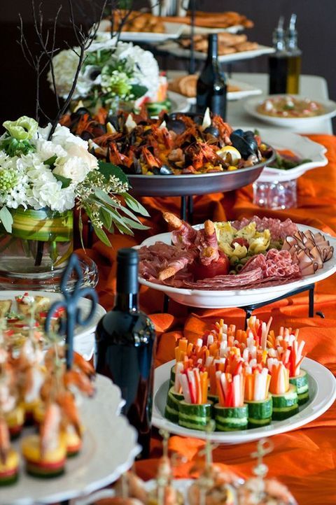 an assortment of appetizers and snacks are on the buffet table at a wedding reception