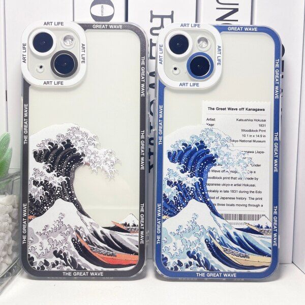 two phone cases with the great wave on them are sitting next to each other in front of a plant