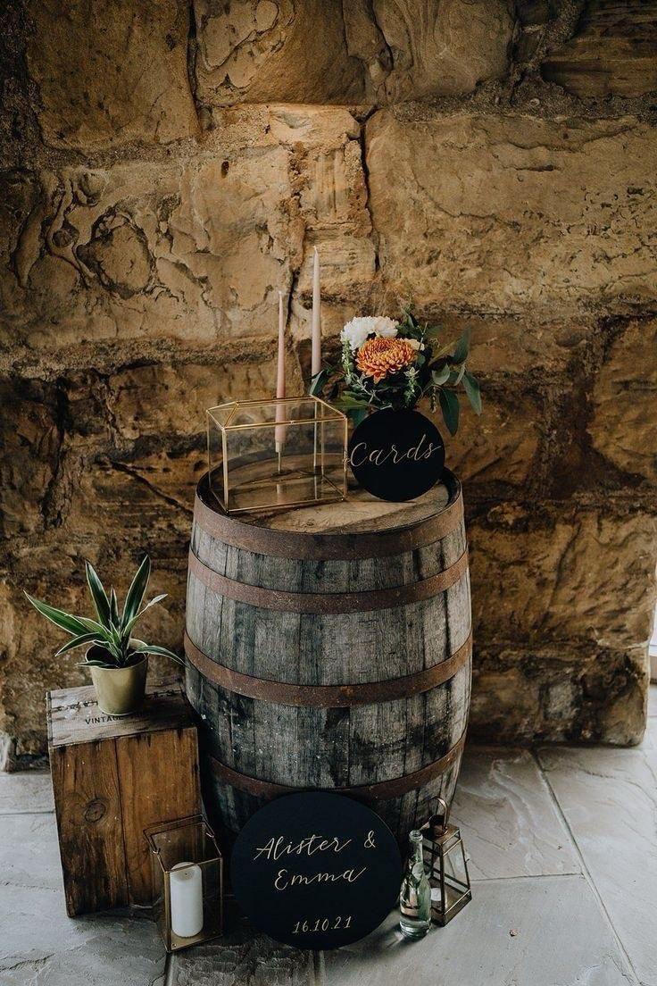 a wooden barrel with candles and flowers on it