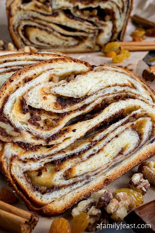 cinnamon swirl bread is cut in half and stacked on top of each other with cinnamon sticks