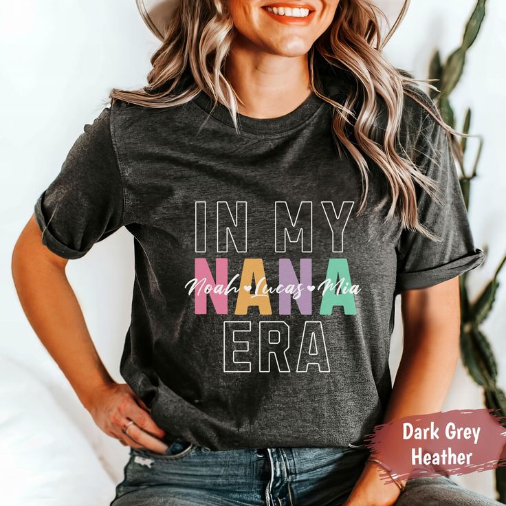 ABOUT OUR CUSTOM CUSTOM NANA T-SHIRT Perfect as a gift or a treat for yourself, our Custom Nana T-shirt is designed to honor the special bond between a grandmother and her grandchildren. This custom tee features the heartfelt phrase "In My Nana Era" along with the names of her beloved grandkids, making it a unique and cherished keepsake. Add a touch of personalized joy to any occasion with this lovingly crafted shirt! ✨ PRODUCT INFORMATION ✨ -Bella + Canvas 3001 Unisex Jersey Short Sleeve Tee  - Nana Shirts Ideas, Grandma Era, Nana T Shirts, Nana Grandma, Nana Shirts, Custom Tee, Nana Gifts, Roll Up Sleeves, Custom Tees