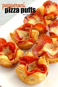 small pizza puffs are arranged on a cutting board