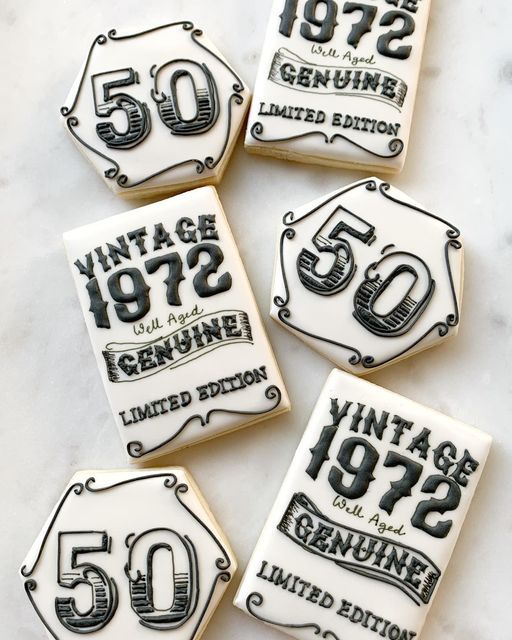 four decorated cookies with the number 50 on them and an old fashioned sign in black