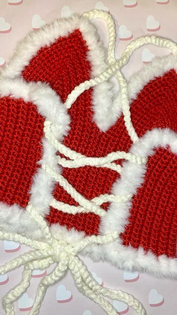 red and white knitted mittens on top of a polka dot table cloth