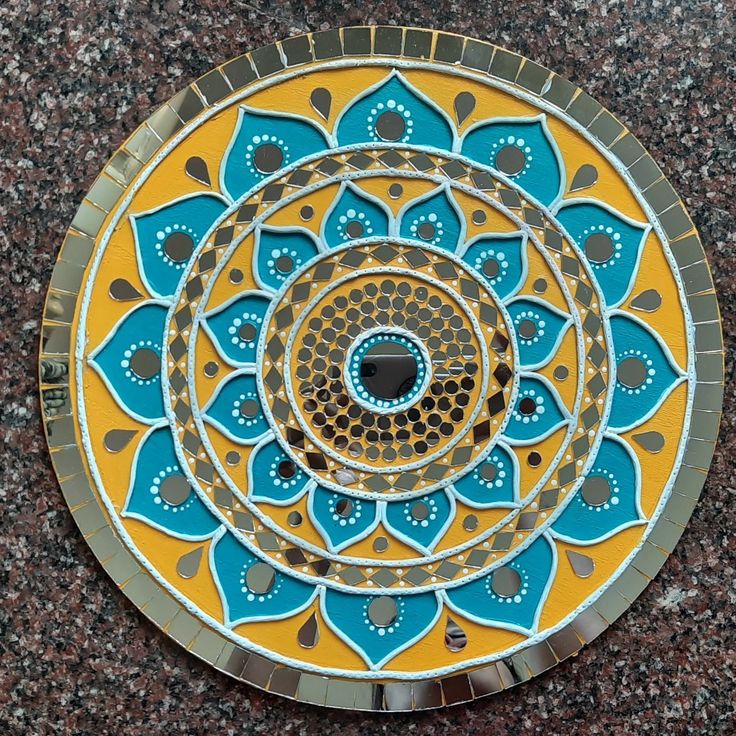 a circular design on the ground with blue and yellow colors