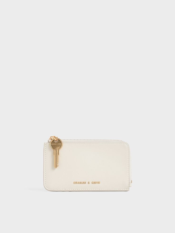 Give your essentials a classy home in this mini wallet. Featuring a compact size and a fresh cream white colour, this piece knows what it is doing when it comes to both function and style. Take note of the unique key feature that replaces the normal zipper pull tab, spicing up the minimalist design. Perfect for the modern woman to slip into her bag and start the day. Classy Home, Cream White Color, Unique Key, Fresh Cream, Charles Keith, Mini Wallet, Start The Day, White Colour, Pull Tab