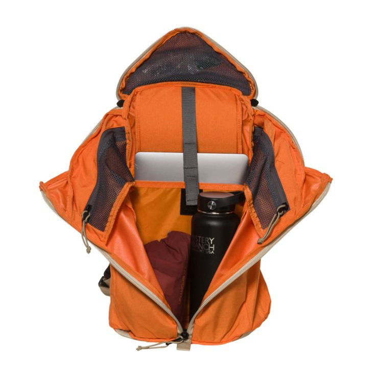 an orange backpack filled with items on top of it