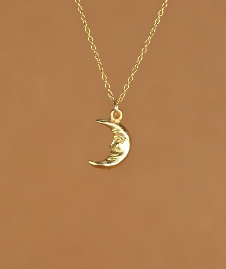 Smiling moon necklace, happy moon pendant, celestial necklace, happy necklace, a gold moon charm on a gold vermeil chain A happy little gold vermeil crescent moon dangles from a 14k gold vermeil chain in the length of your choice! This happy little moon measures 12mmx8mm More from BubuRuby? https://www.etsy.com/shop/BubuRuby?ref=seller-platform-mcnav Looking for other charm necklaces? https://www.etsy.com/shop/BubuRuby?section_id=12318467 More from Bubu Ruby? https://www.etsy.com/shop/BubuRuby?r Dainty Brass Moon Charm Necklace, Dainty Moon Phase Charm Necklace, 14k Gold Celestial Moon Charm Necklace, Everyday Moon Charm Necklaces, Everyday Moon Charm Necklace, 14k Gold Filled Moon Charm Necklace As A Gift, Dainty Half Moon Phase Charm Necklace, Dainty Gold-plated Moon Charm Necklace, Dainty Half Moon Charm Necklace With Moon Phase