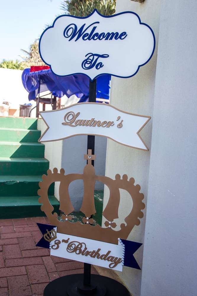 a welcome sign for someone's birthday with a crown on it and a blue ribbon