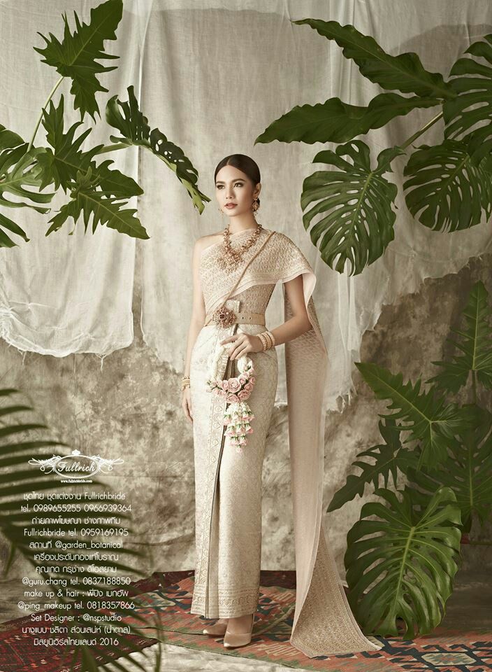 a woman standing in front of some plants