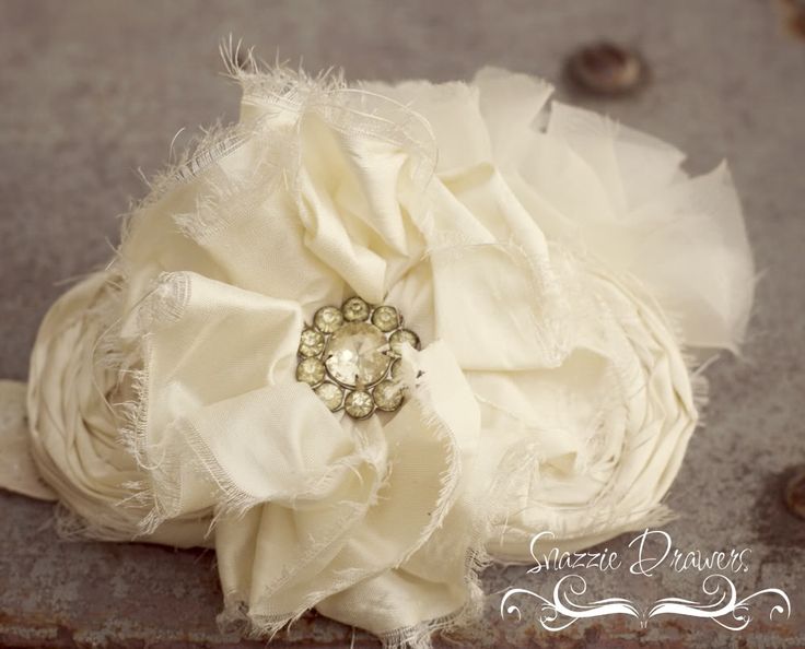 the bridal bouquet is made with white fabric and brooches, along with pearls