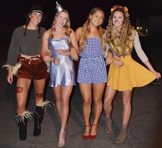 four women dressed up in costumes posing for the camera