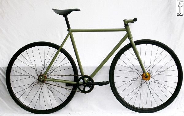 a green bike with black spokes is shown against a white background