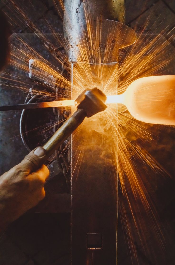 welder working on an object with sparks coming from it