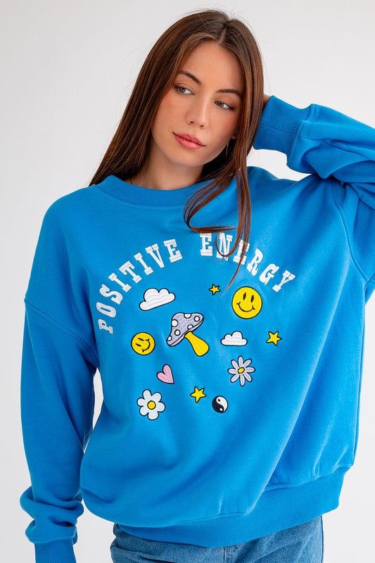 Blue embroidered oversized cozy sweatshirt. Comfortable Blue Sweats With Ribbed Cuffs, Comfy Blue Sweats With Ribbed Cuffs, Blue Crew Sweatshirt For Spring, Blue Crew Neck Sweatshirt For Spring, Blue Crew Neck Spring Sweatshirt, Cozy Fit Blue Sweatshirt With Ribbed Cuffs, Comfy Blue Cotton Sweats, Cozy Blue Sweats For Fall, Oversized Comfortable Sweatshirt With Graphic Print