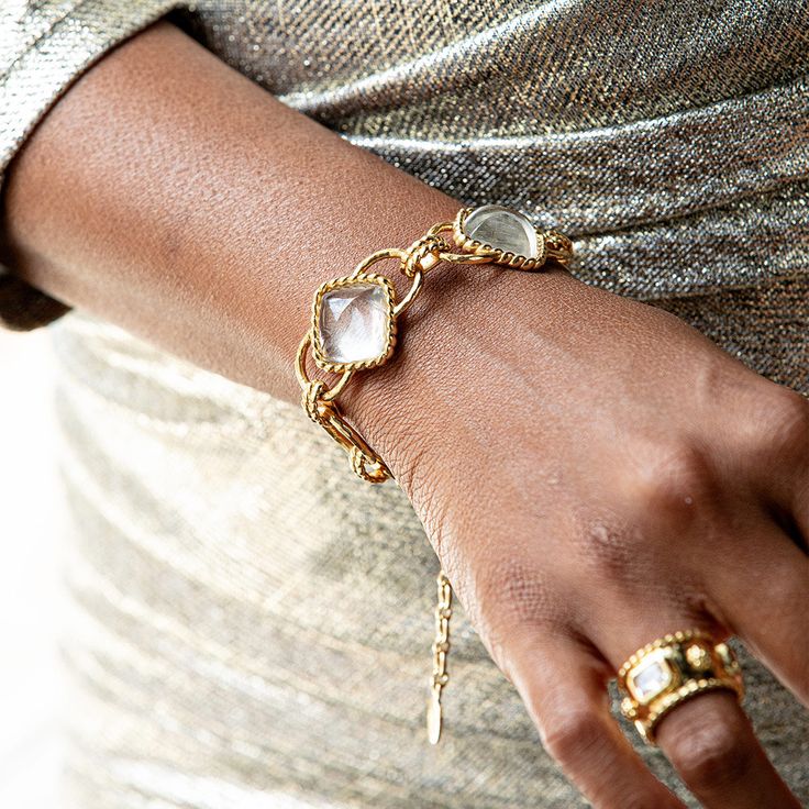 This versatile piece elevates the classic chain bracelet with an unexpected twist, artfully rendered with understated clear quartz beads and a subtly ornate gold motif for a dash of drama. Inspired by the effortless-yet-impeccable style that my fabulous French aunt achieves every day, who is able to take everything from a ballgown to a t-shirt, and make a moment of it. Pair with our Blandine Chain necklace to complete the look. Elegant White Bracelets With Gold Chain, Elegant Adjustable Crystal Bracelet With Chain, Elegant Crystal Chain Bracelet Gift, Elegant Clear Bracelets As Gift, Elegant Clear Bracelet As Gift, Elegant Clear Bracelet Perfect For Gifts, Elegant Crystal Bracelet With Adjustable Chain, Elegant Clear Jewelry With Adjustable Chain, Elegant Clear Gemstone Jewelry