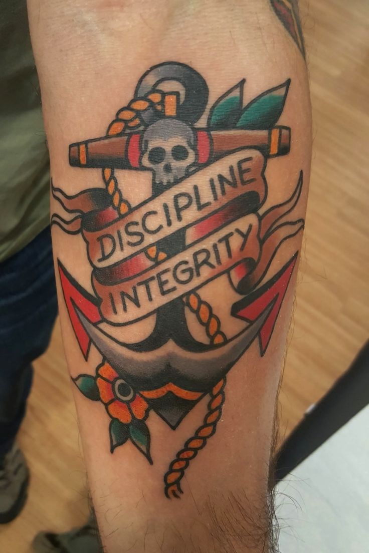 a man's arm with a tattoo on it that says discipline integitity